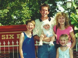 Christel family in front of Six Flags amusement park train