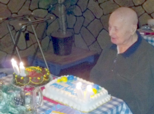 Photo of George Christel, age 103 with birthday cakes
