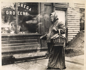 Shopper in front of John Grega's grocery store