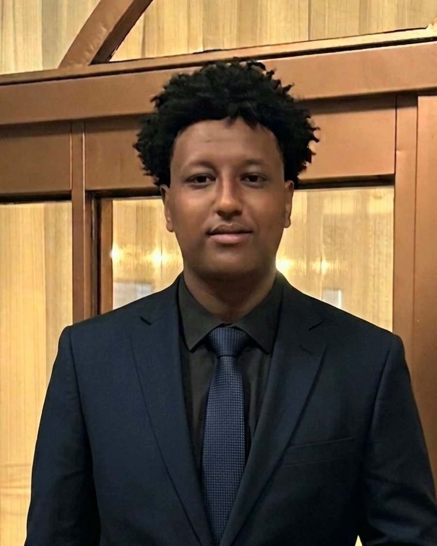 Portrait of Liyu Getaneh Berhanu in a navy suit and tie